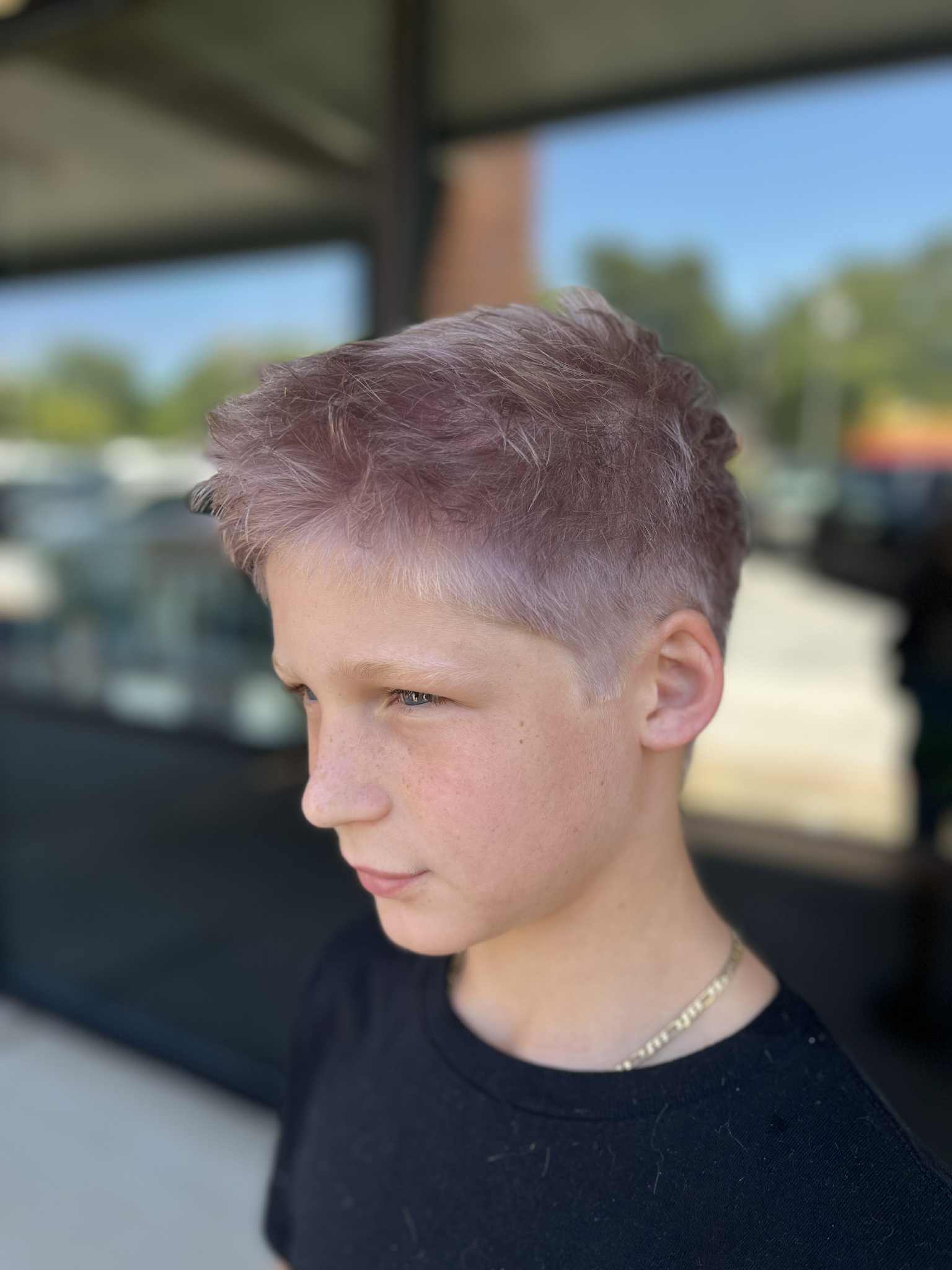 Teen with a tousled fade and lavender-toned hair